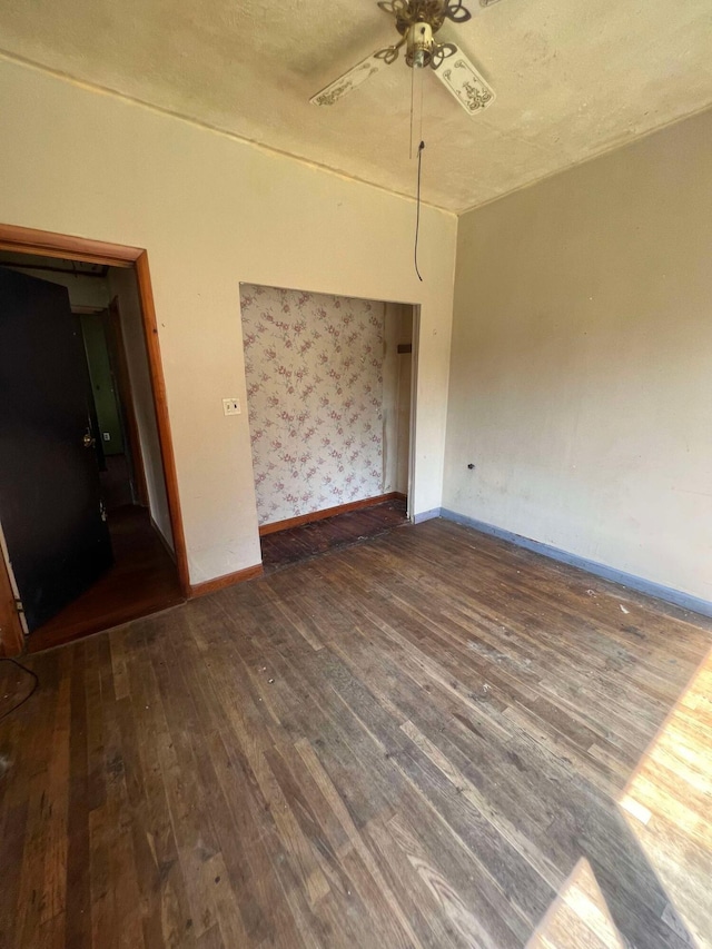 unfurnished bedroom with ceiling fan and dark hardwood / wood-style floors