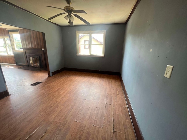 interior space with hardwood / wood-style flooring, ornamental molding, a healthy amount of sunlight, and ceiling fan