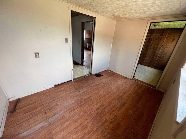 unfurnished room with hardwood / wood-style floors