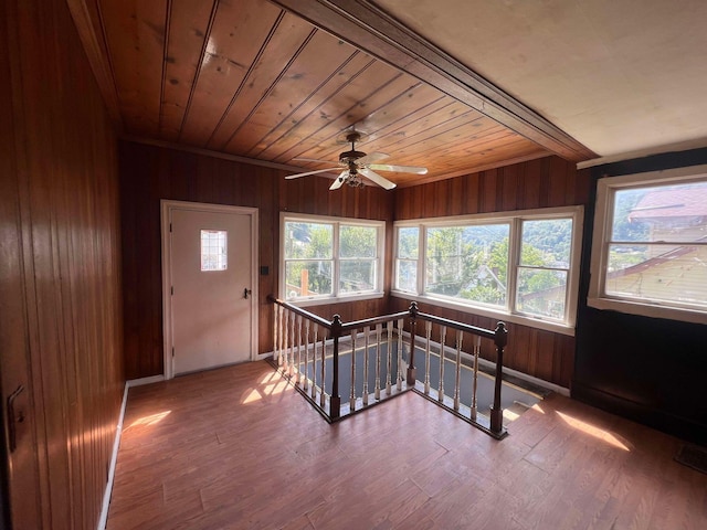 unfurnished sunroom with wooden ceiling and ceiling fan
