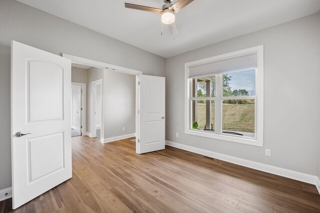 foyer entrance featuring ceiling fan, hardwood / wood-style floors, and a wealth of natural light