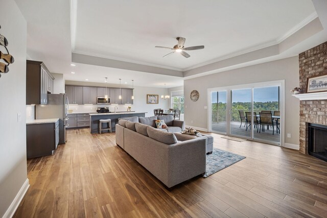 living room featuring ceiling fan, a fireplace, and hardwood / wood-style floors