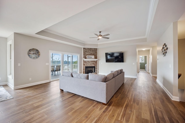 1830 Hunter Dr, Lancaster, KY 40444 - living area featuring a raised ceiling, wood finished floors, a ceiling fan, and a fireplace