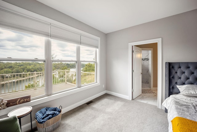 carpeted bedroom featuring a water view