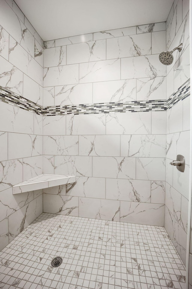 bathroom with a tile shower