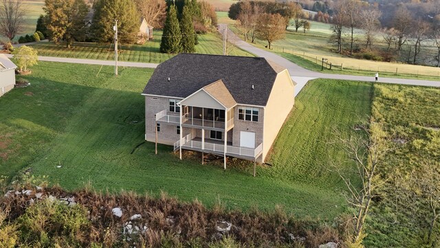 craftsman inspired home featuring a water view, a porch, a garage, and a front lawn