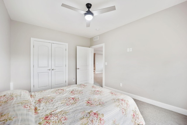 carpeted bedroom with ceiling fan, a closet, visible vents, and baseboards