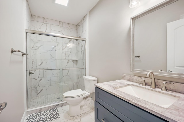 full bath with toilet, marble finish floor, a stall shower, and vanity