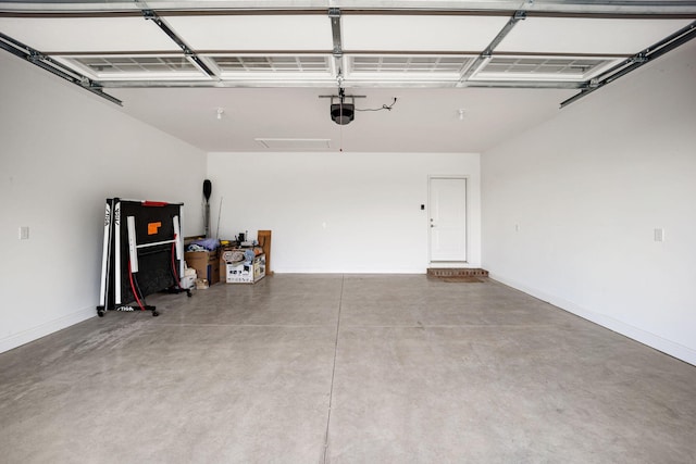 garage with baseboards and a garage door opener