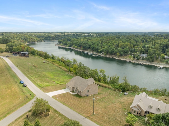 aerial view featuring a water view and a wooded view