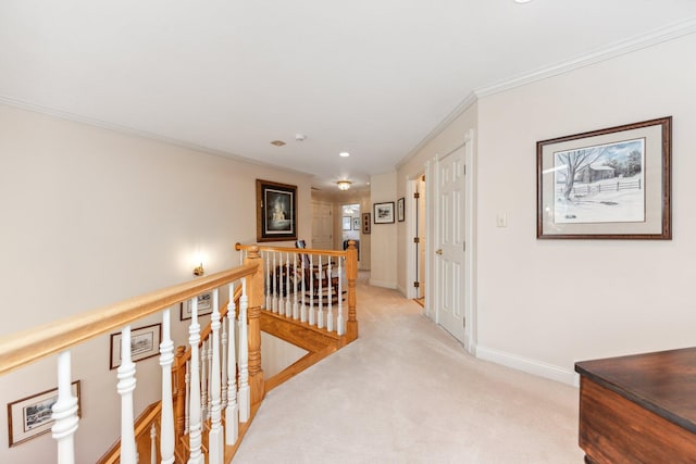 hallway with crown molding and light colored carpet