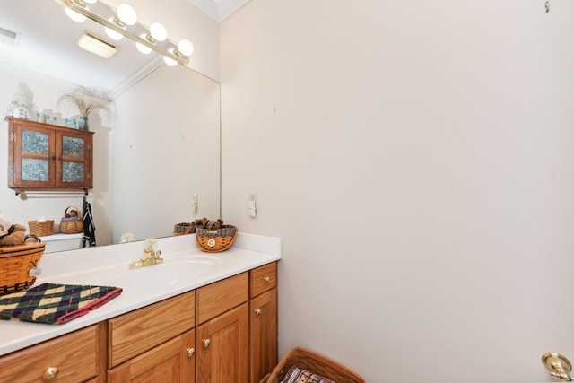 bathroom with vanity and ornamental molding