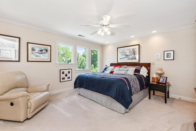 carpeted bedroom featuring ceiling fan and ornamental molding