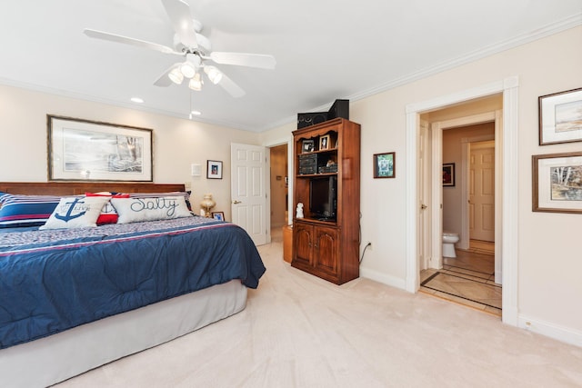 carpeted bedroom with crown molding, ensuite bathroom, and ceiling fan