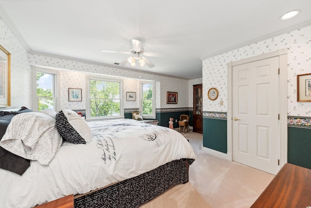 bedroom with ceiling fan, crown molding, and light carpet