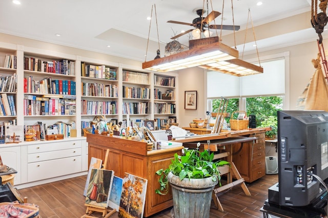 office area with crown molding, dark wood-type flooring, and ceiling fan