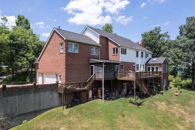 rear view of property with a garage, a lawn, and a deck