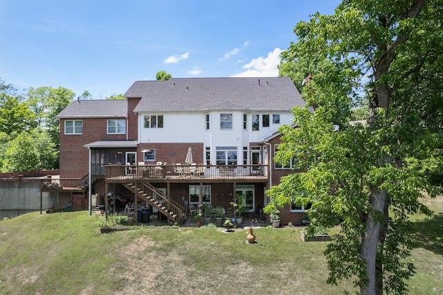 rear view of property with a yard and a deck