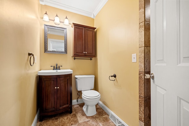 bathroom with toilet, vanity, and ornamental molding