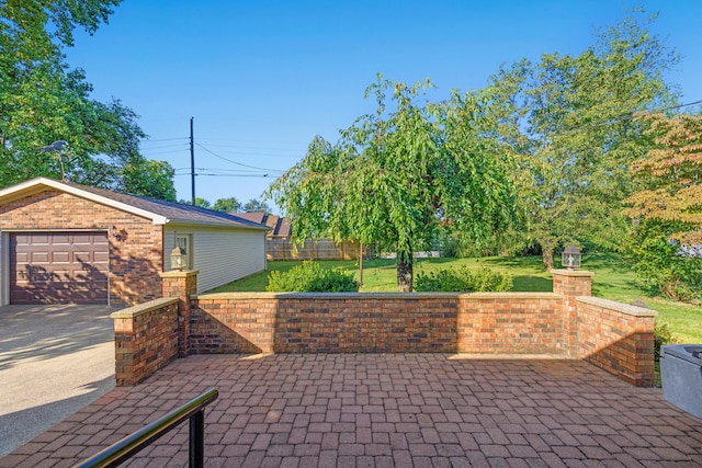 view of patio featuring an outbuilding and a garage