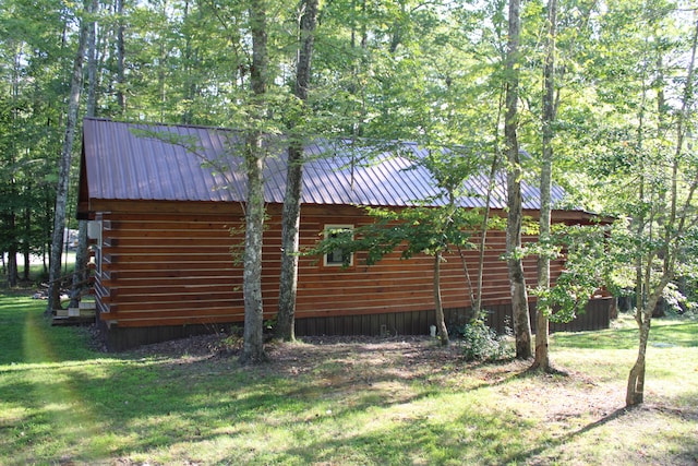 view of side of property with a yard