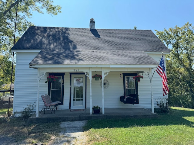 bungalow-style home with a front lawn and covered porch