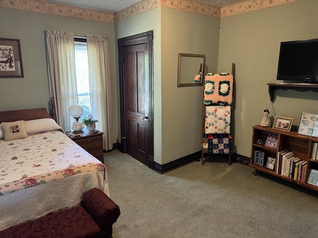 bedroom with light carpet and baseboards