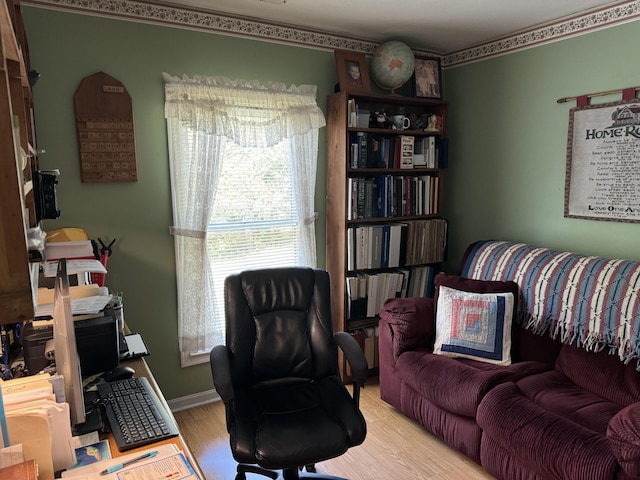 home office featuring baseboards and wood finished floors