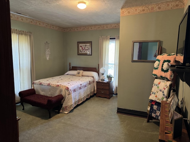 carpeted bedroom featuring visible vents and a textured ceiling