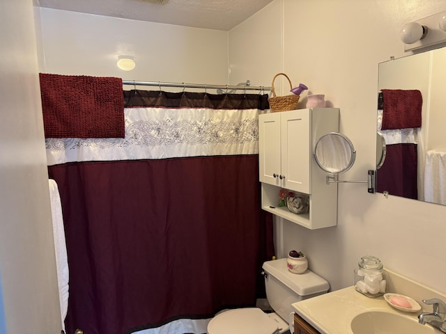 bathroom featuring vanity, toilet, and a shower with curtain