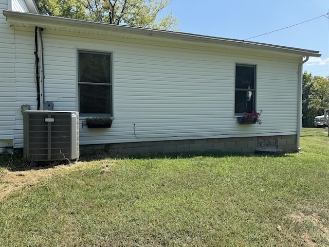 view of home's exterior featuring crawl space, cooling unit, and a yard