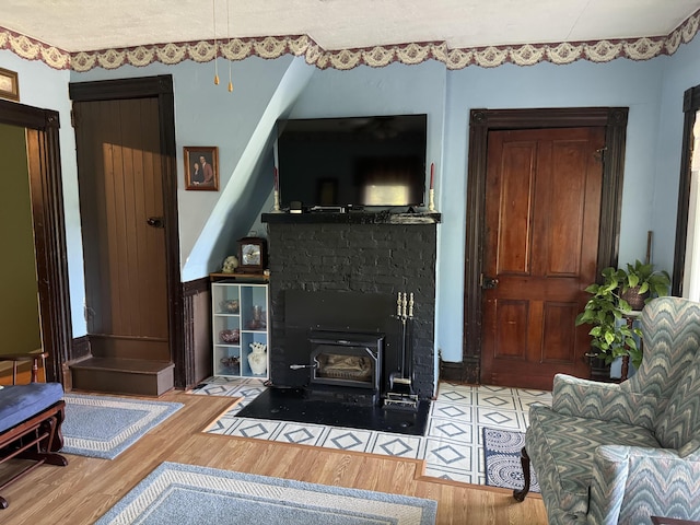 living area featuring a wood stove and wood finished floors