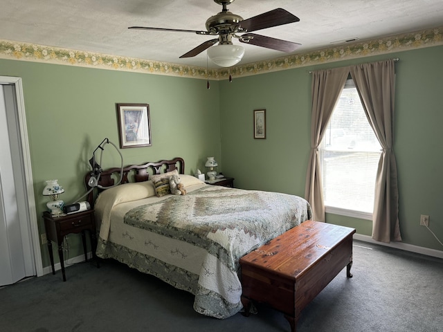 carpeted bedroom featuring visible vents, baseboards, a textured ceiling, and a ceiling fan