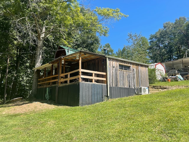 view of outbuilding with a lawn