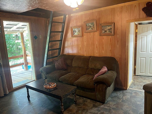 tiled living room with a textured ceiling and wooden walls