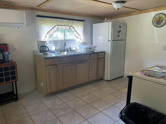 kitchen featuring white appliances, a wall mounted air conditioner, sink, and light tile patterned flooring