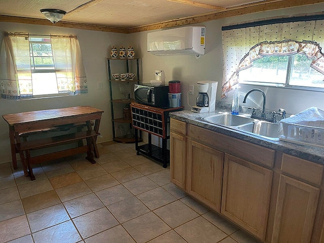 kitchen with an AC wall unit, light tile patterned floors, crown molding, and sink