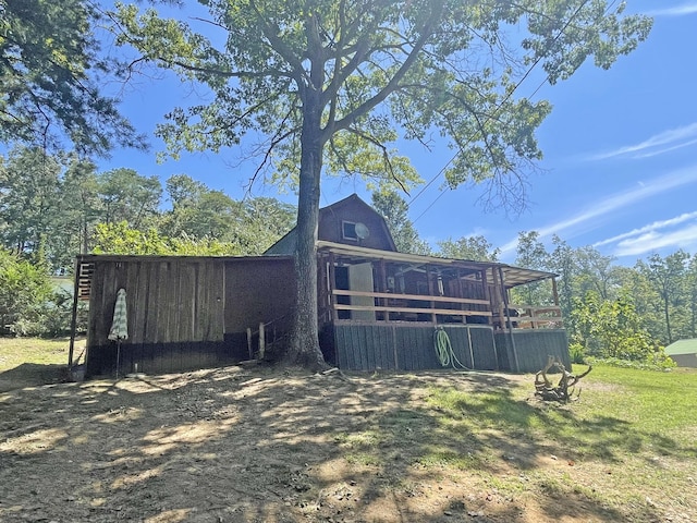 rear view of property with an outdoor structure