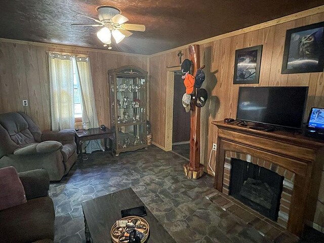 living room featuring a brick fireplace, wood walls, and ceiling fan