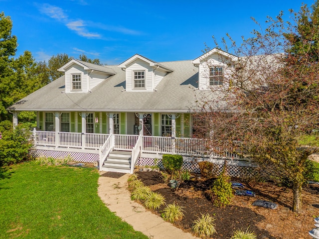 view of front facade with a front yard and covered porch