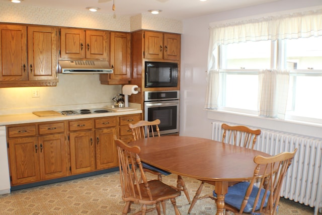 kitchen with radiator and white appliances