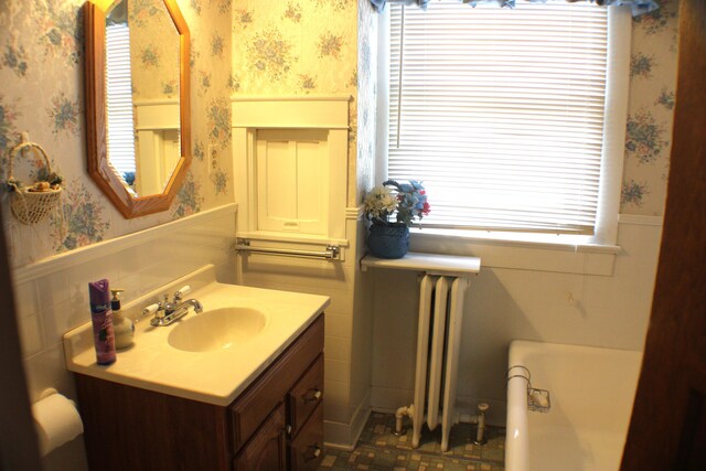 bathroom featuring vanity, radiator heating unit, and tile patterned floors