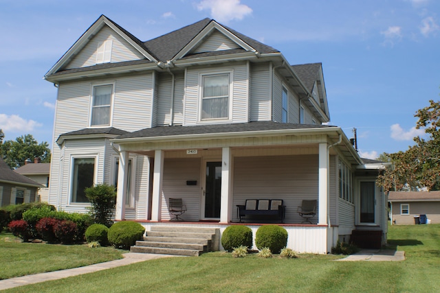 view of front of home with a porch and a front yard