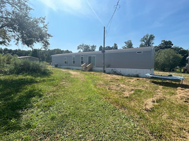 exterior space featuring a lawn and a trampoline