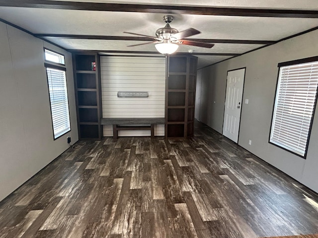 unfurnished living room featuring dark wood-type flooring, ceiling fan, and a textured ceiling