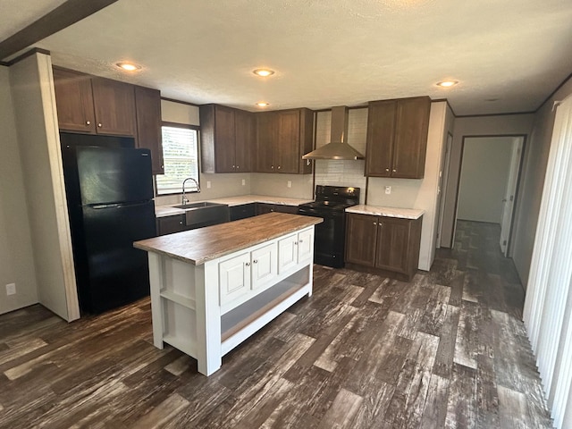 kitchen with dark hardwood / wood-style floors, black appliances, a center island, sink, and wall chimney range hood