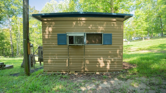 view of outbuilding featuring a yard