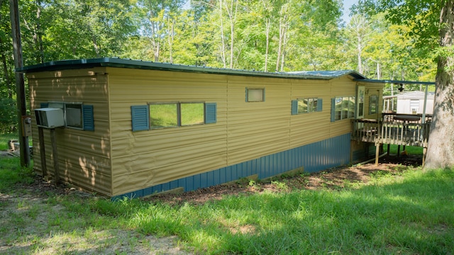 view of side of home featuring a wooden deck