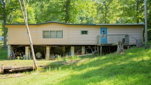 rear view of property featuring a wooden deck