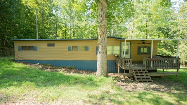 exterior space featuring ceiling fan and a deck